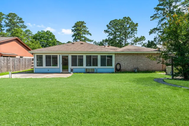 a view of a house with a backyard