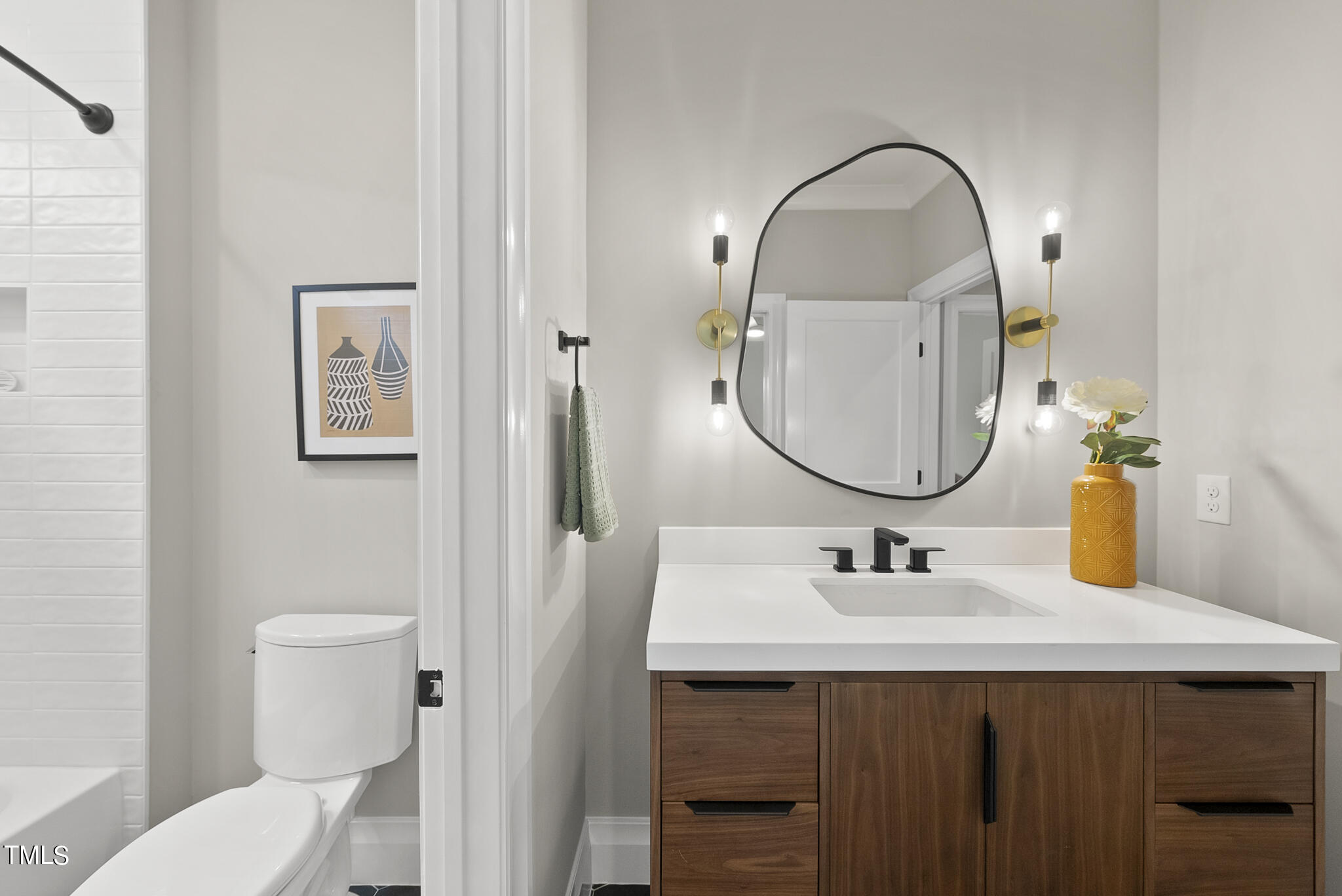3414 Bradley Place Raleigh, NC 27607 - Photo 28 of 37 a bathroom with a sink and a mirror with toilet