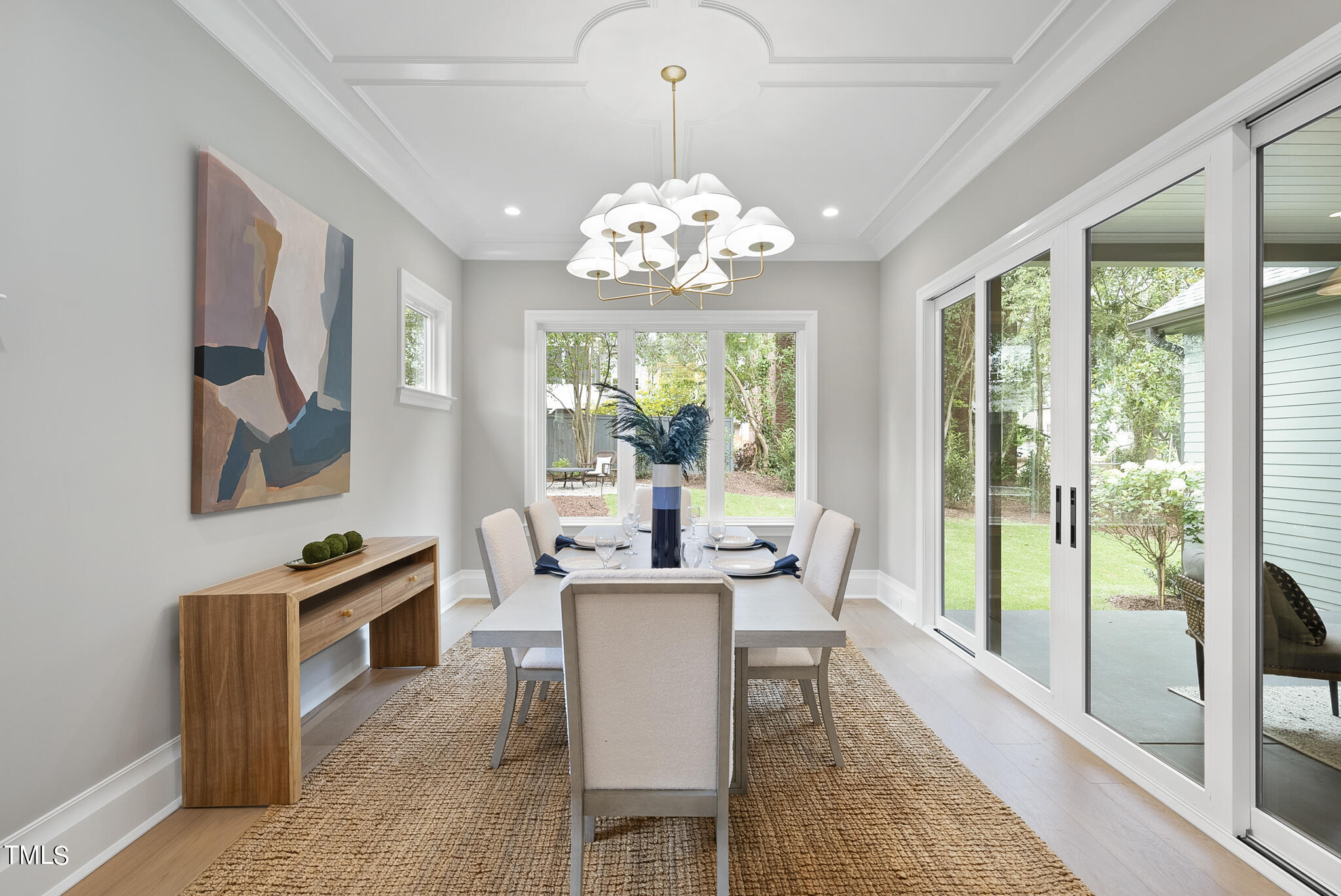 3414 Bradley Place Raleigh, NC 27607 - Photo 9 of 37 a view of a dining room with furniture a chandelier and large windows