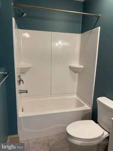a bathroom with a toilet and a bathtub