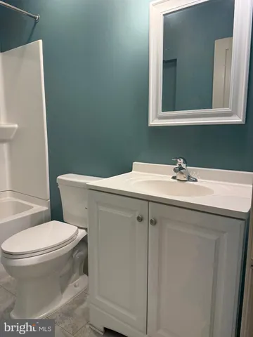 a bathroom with a sink mirror and toilet