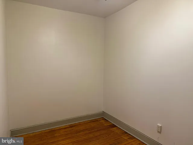 a view of a small space with wooden floor and a window