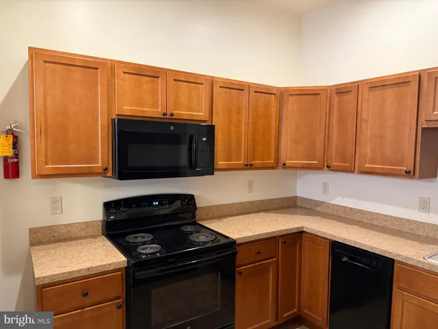 a kitchen with stainless steel appliances a stove microwave and sink