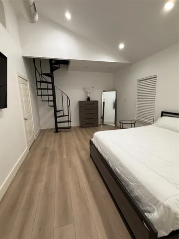 a spacious bedroom with a bed and a walk in closet