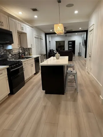 a view of kitchen with refrigerator stove microwave and cabinets