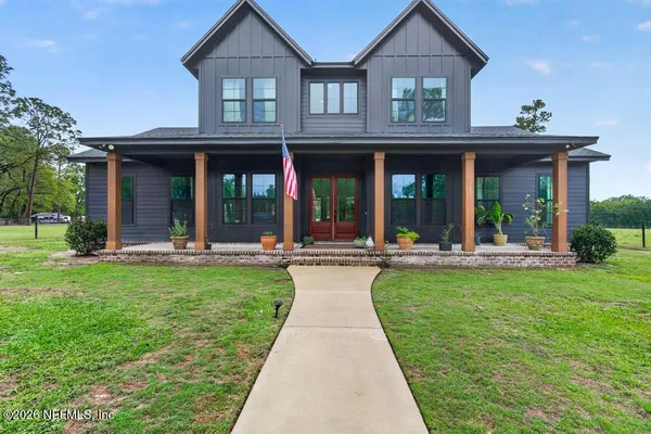 a view of a house with backyard porch and sitting area