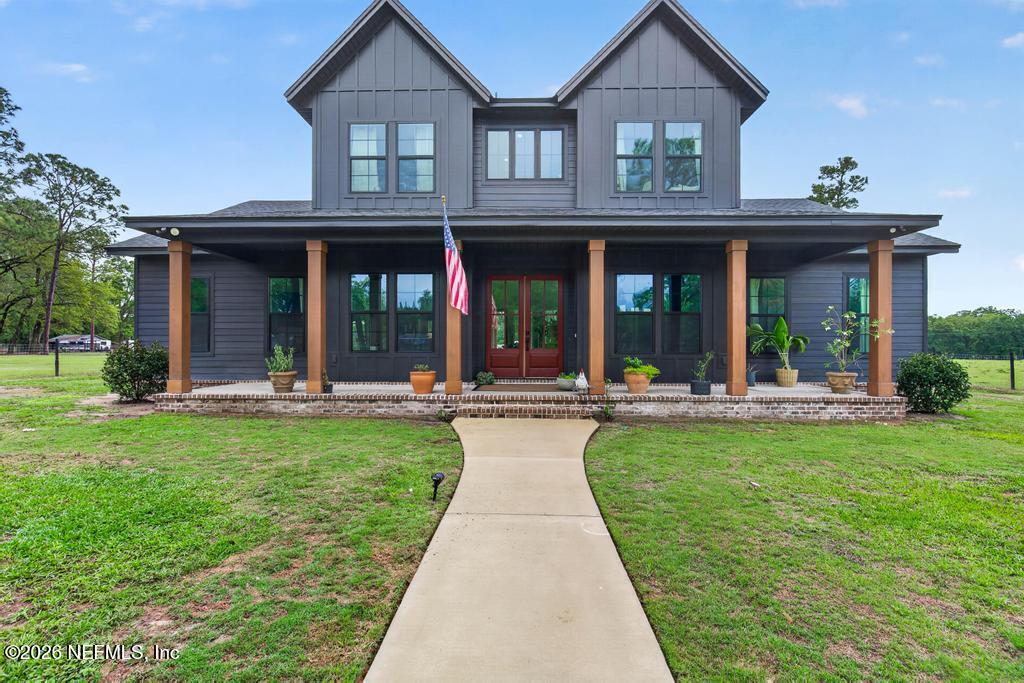 a view of a house with backyard porch and sitting area