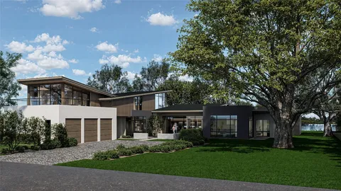 a front view of a house with a garden and trees