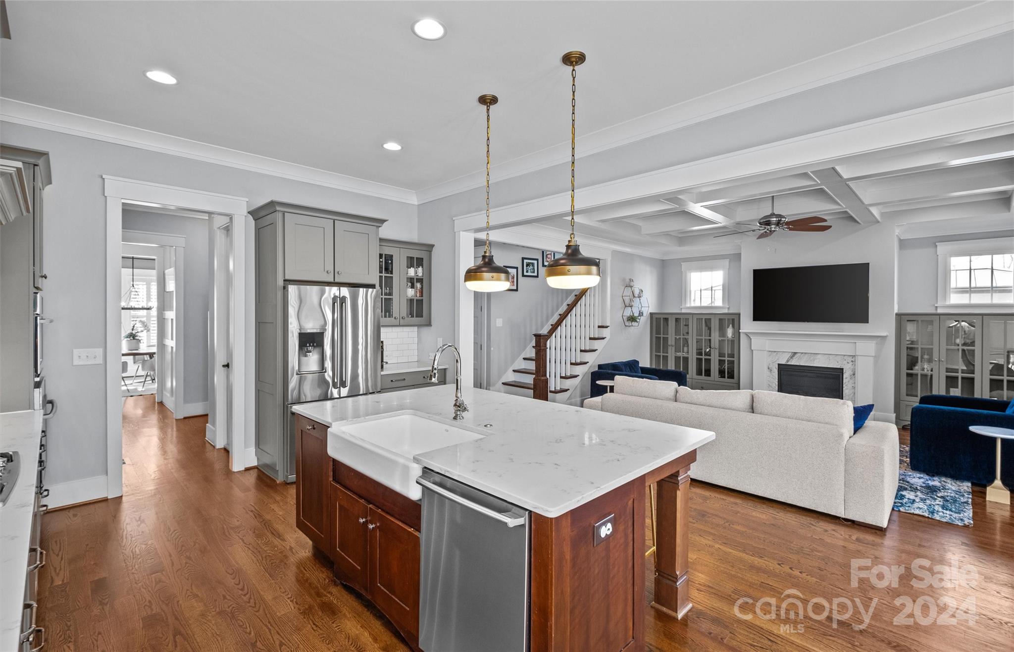 149 McAlway Road Charlotte, NC 28211 - Photo 13 of 48 a view of living room kitchen with stainless steel appliances kitchen island wooden floor and living room view