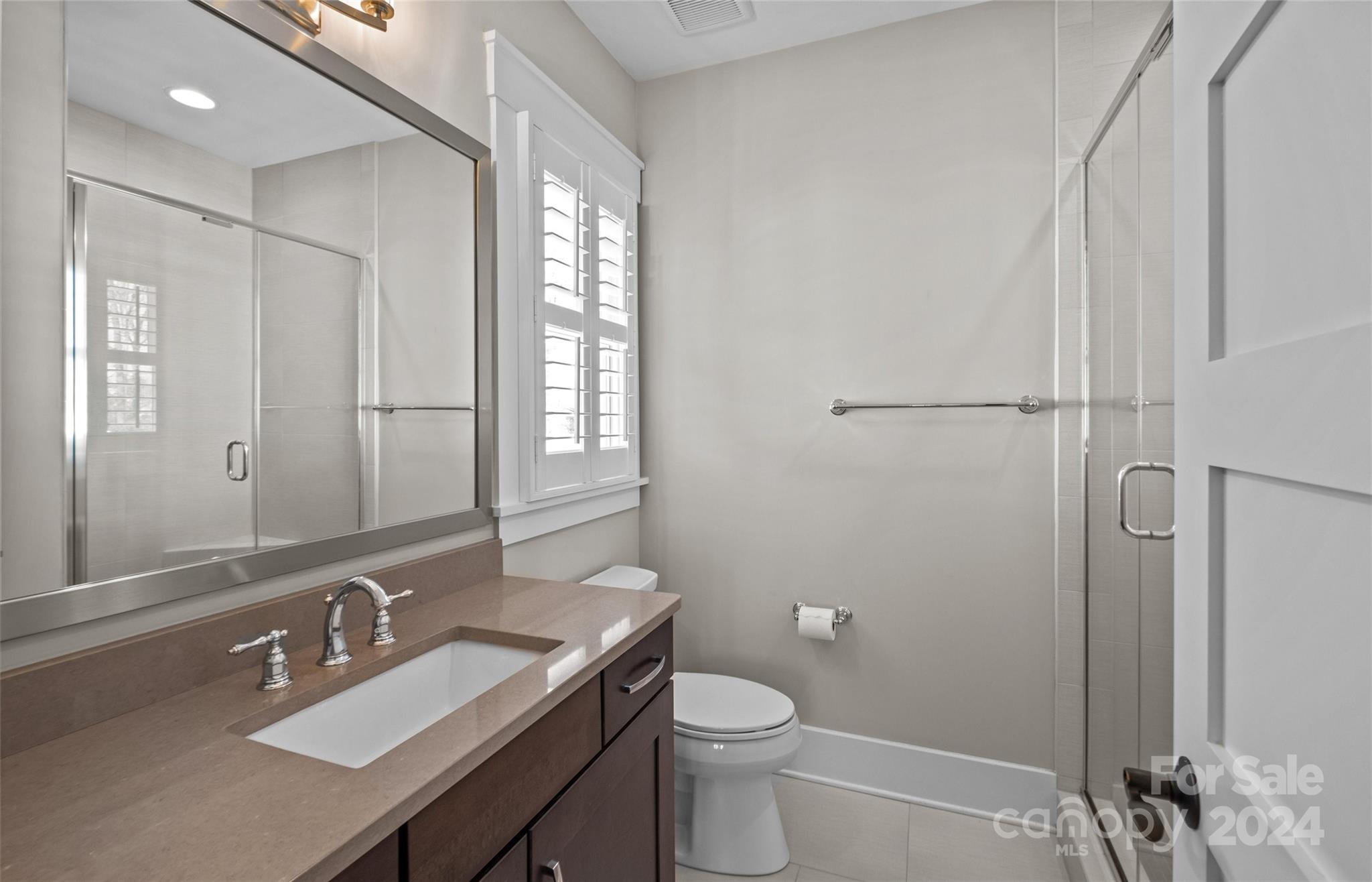 149 McAlway Road Charlotte, NC 28211 - Photo 35 of 48 a bathroom with a sink a toilet a mirror and vanity