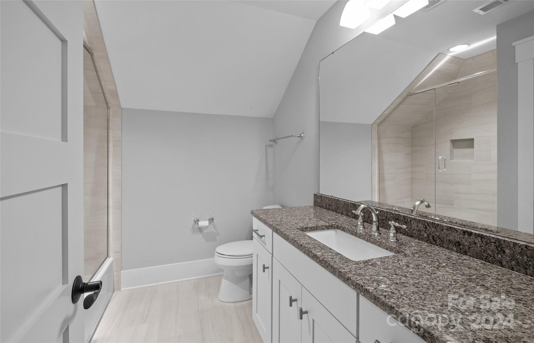 149 McAlway Road Charlotte, NC 28211 - Photo 39 of 48 a bathroom with a granite countertop sink a toilet and a mirror