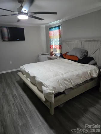 a bedroom with a bed and a tv