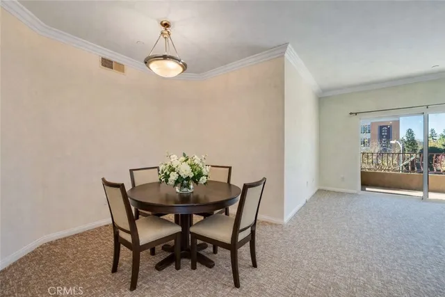 a view of a dining room with furniture and chandelier