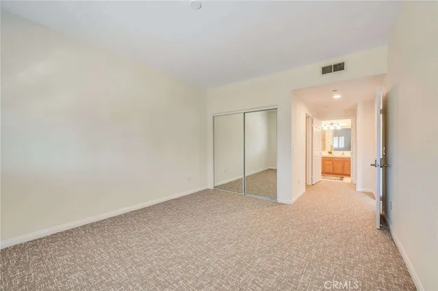 a view of an empty room and a bathroom
