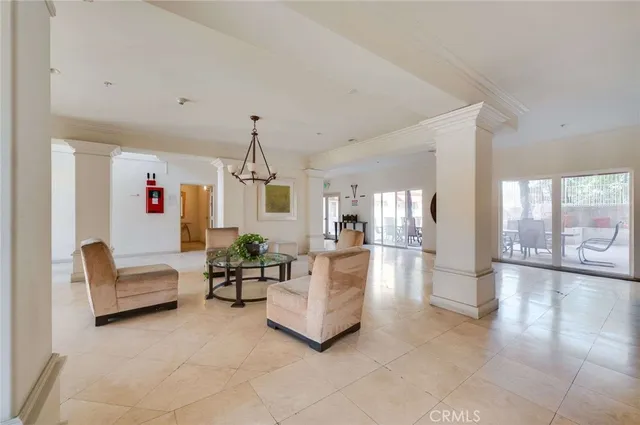 a living room with furniture and a chandelier