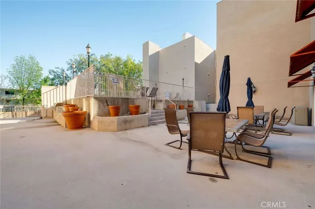 a outdoor space with patio the couches and a potted plant on the roadside