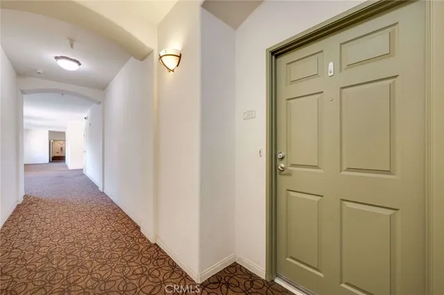 a view of a hallway with wooden floor and entryway