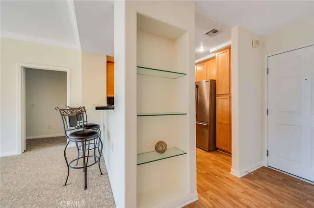 a view of a kitchen with furniture and a refrigerator
