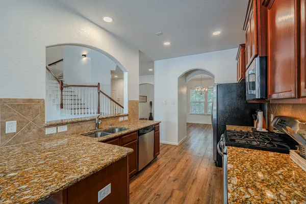 a view of a kitchen cabinets a stove and wooden floor