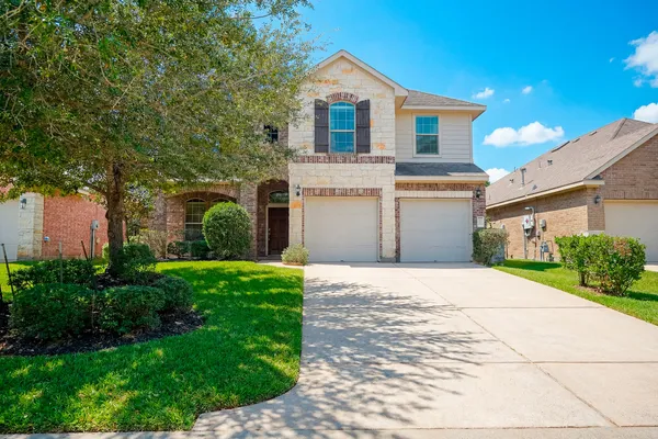 a front view of a house with a yard and garage