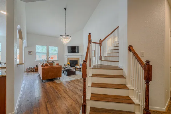 a view of entryway and hall with wooden floor