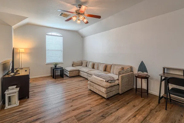 a living room with furniture a fireplace and wooden floor