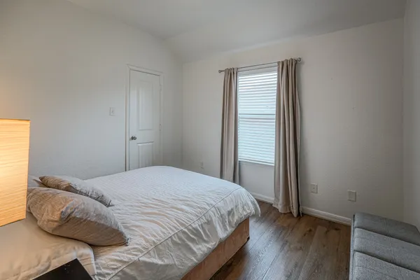 a bedroom with a bed and a window