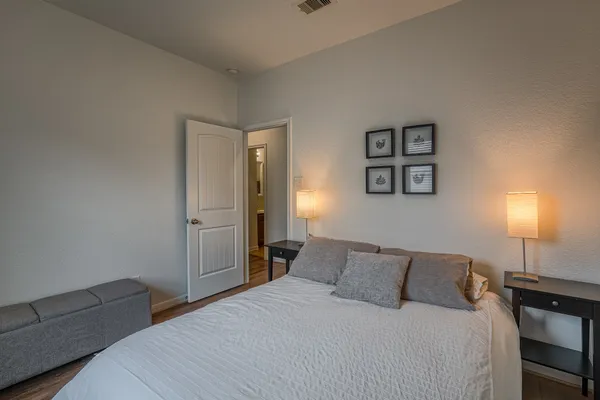 a bedroom with a bed and a lamp