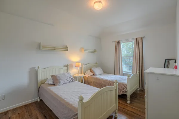 a bedroom with two beds and painted walls