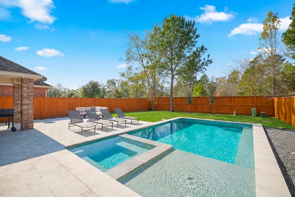 a view of a house with backyard and sitting area