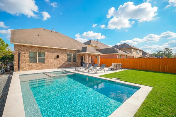 a view of a house with backyard porch and sitting area