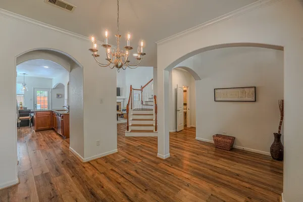 a view of a livingroom with wooden floor and a ceiling fan