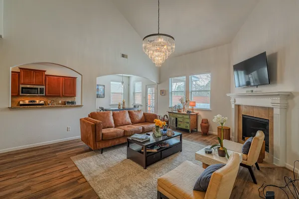 a living room with furniture a fireplace and a flat screen tv