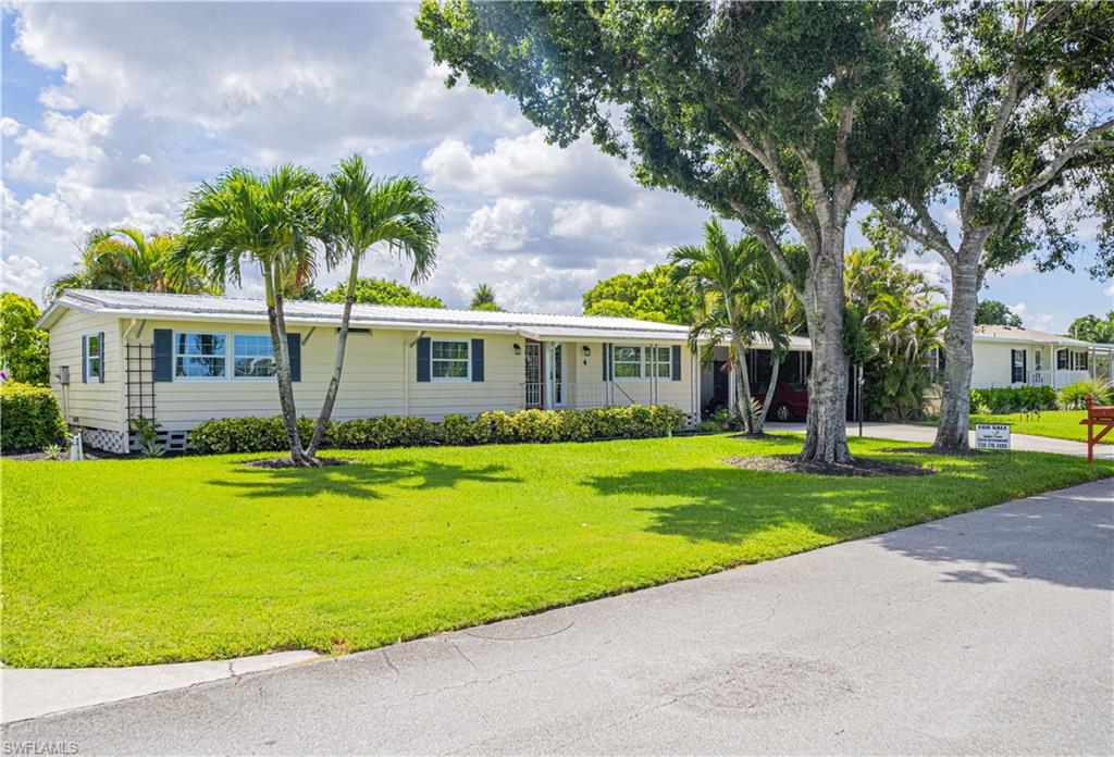 a front view of a house with a yard table and chairs