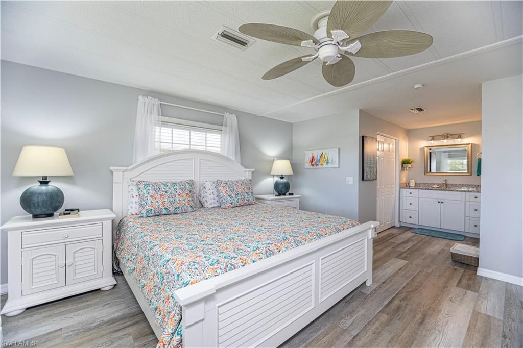 4 Chateau Way Naples, FL 34112 - Photo 12 of 21 a bedroom with a large bed and a chandelier