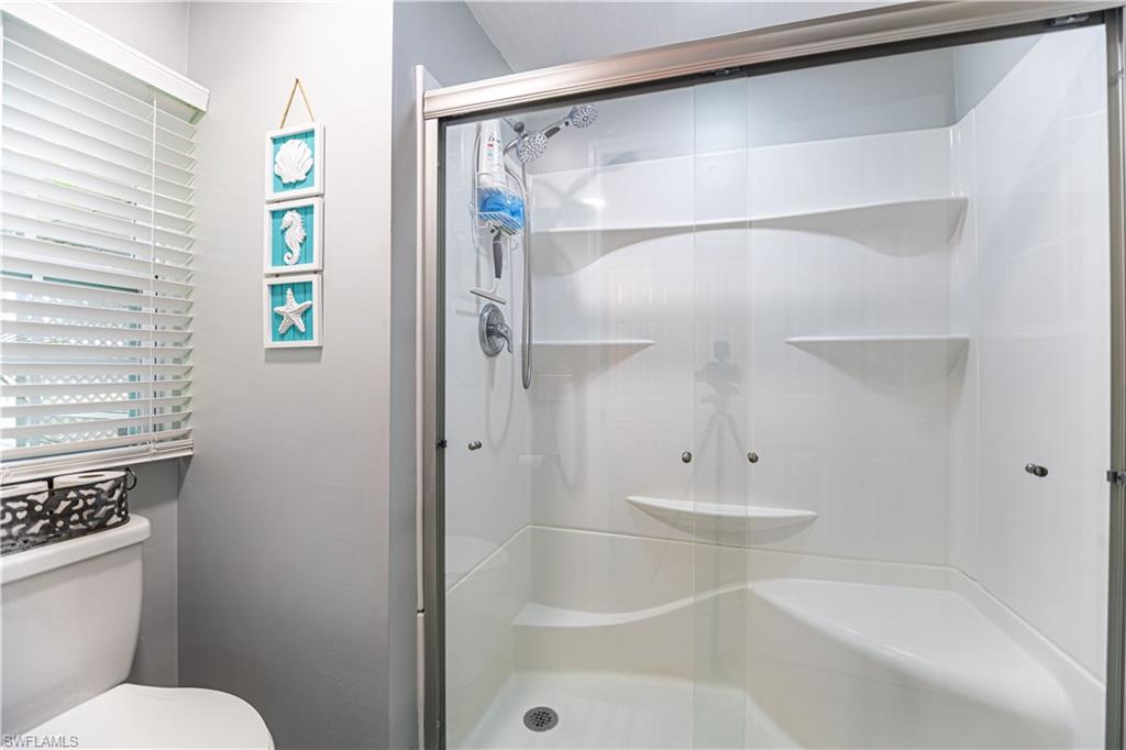 4 Chateau Way Naples, FL 34112 - Photo 14 of 21 a bathroom with a bathtub and a shower
