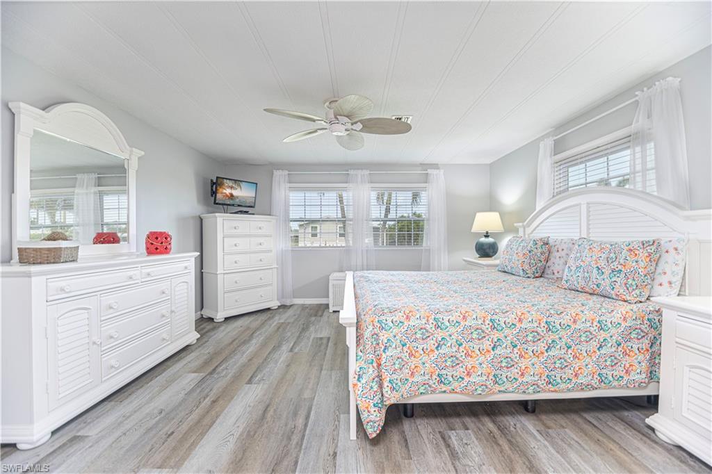 4 Chateau Way Naples, FL 34112 - Photo 16 of 21 a bedroom with a bed and a dresser
