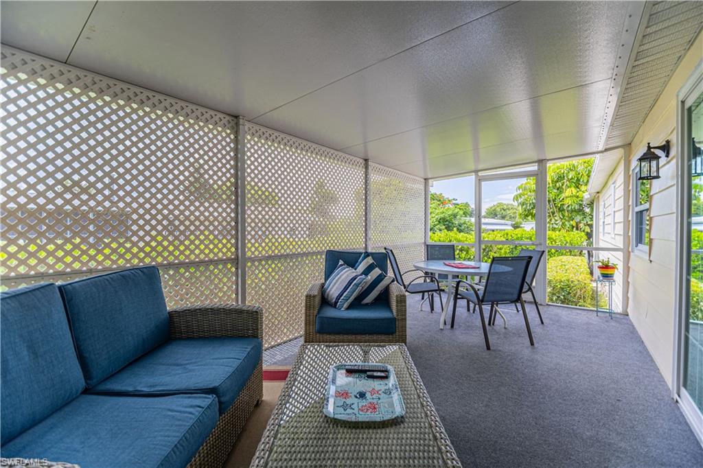 4 Chateau Way Naples, FL 34112 - Photo 18 of 21 a living room with furniture and a large window
