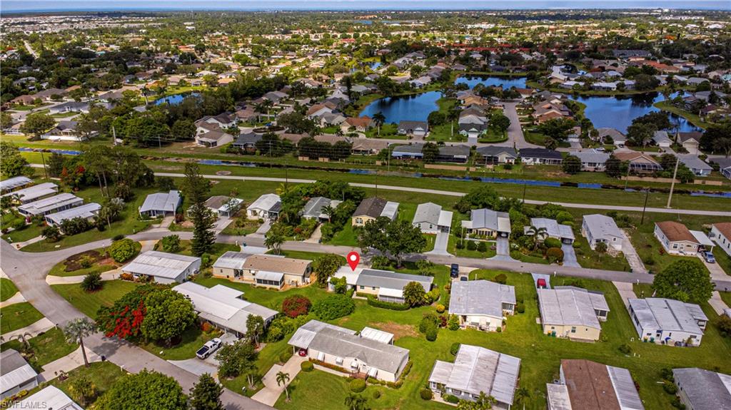 4 Chateau Way Naples, FL 34112 - Photo 20 of 21 an aerial view of a city with lots of residential buildings ocean and mountain view