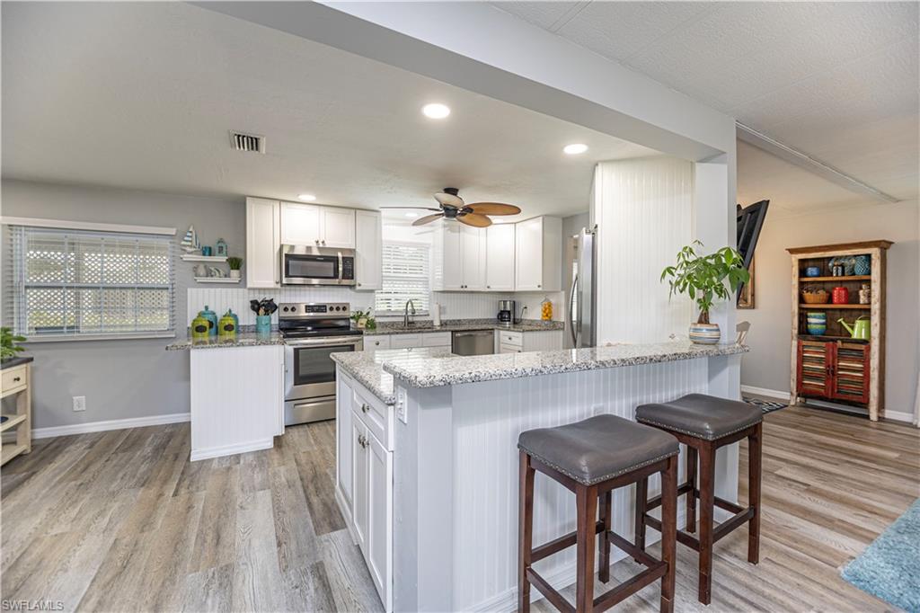 4 Chateau Way Naples, FL 34112 - Photo 7 of 21 a kitchen with a table and chairs in it
