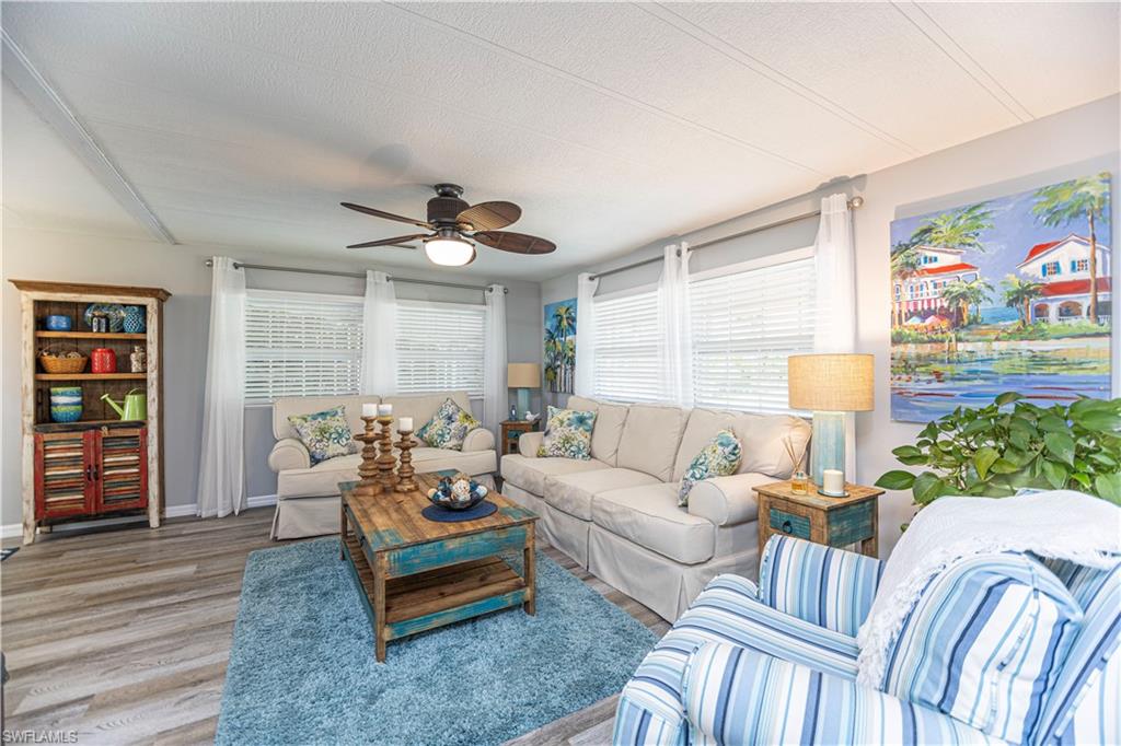 4 Chateau Way Naples, FL 34112 - Photo 8 of 21 a living room with furniture and a wooden floor