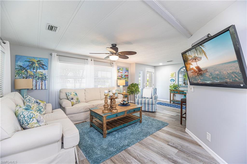 4 Chateau Way Naples, FL 34112 - Photo 9 of 21 a living room with furniture a rug and a flat screen tv
