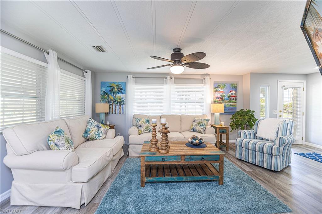 4 Chateau Way Naples, FL 34112 - Photo 10 of 21 a living room with furniture ceiling fan and a rug