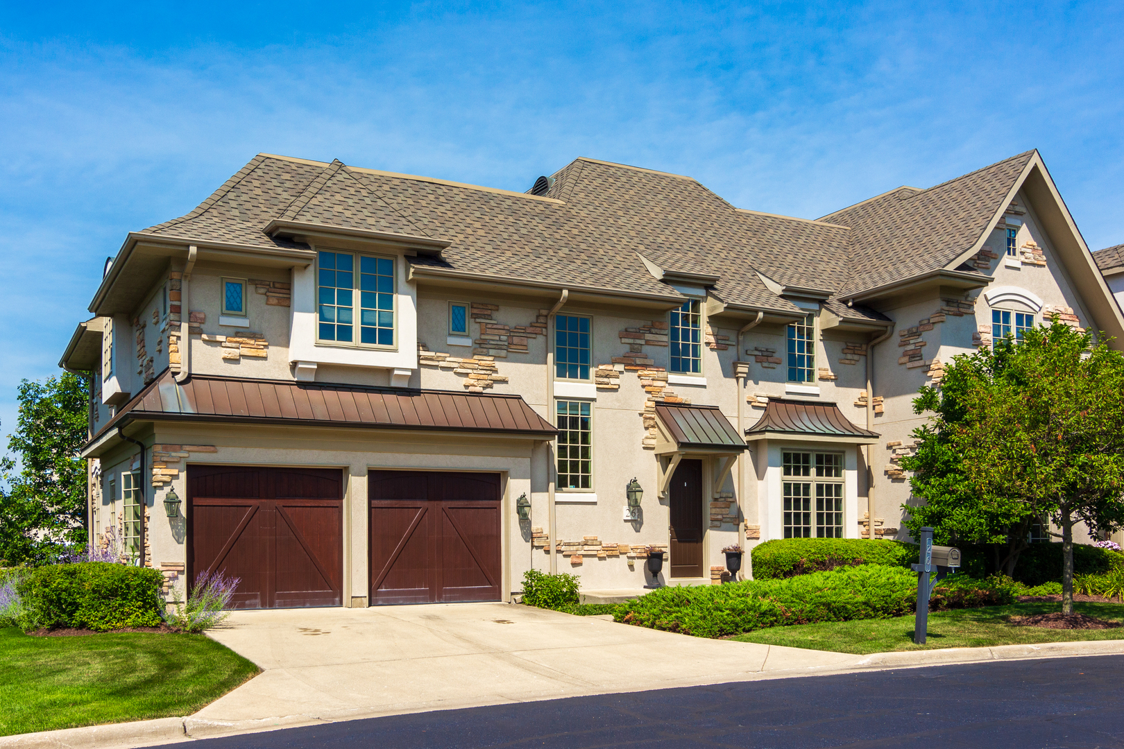 a front view of a house with a garden