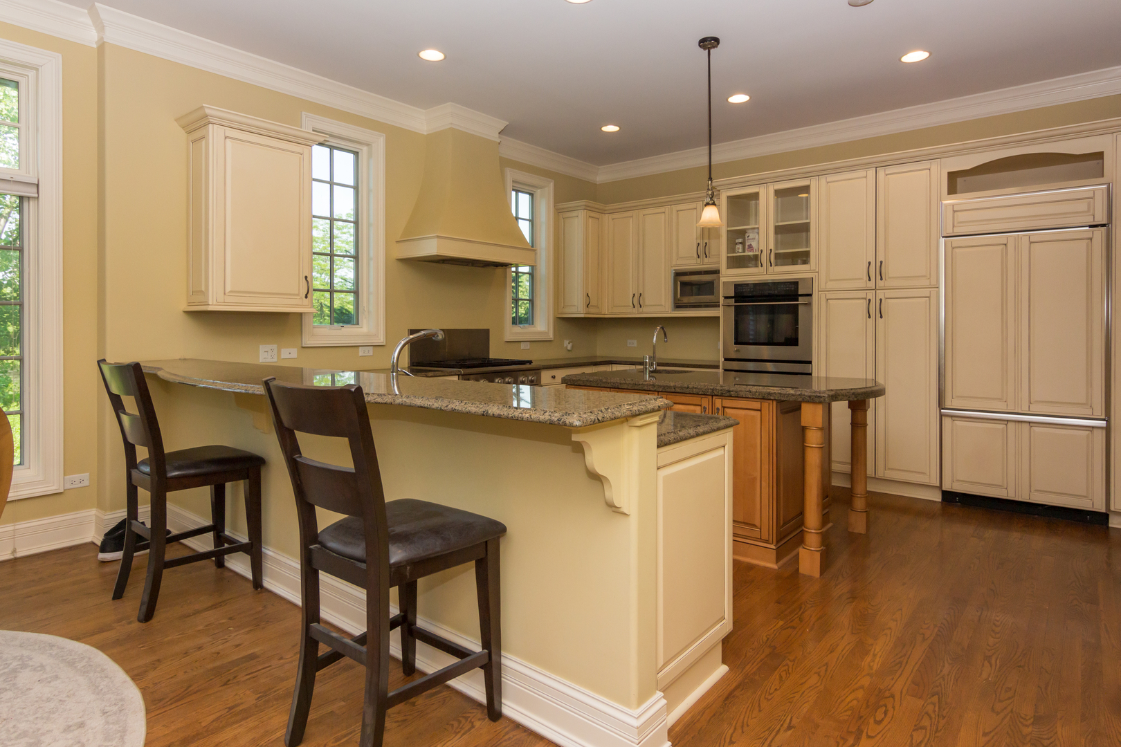 26 Willowcrest Drive Oak Brook, IL 60523 - Photo 3 of 17 a kitchen with kitchen island a large counter top space appliances and a center island