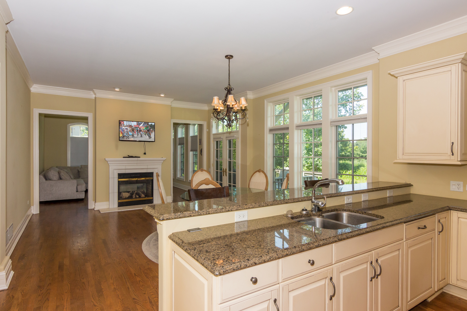 26 Willowcrest Drive Oak Brook, IL 60523 - Photo 4 of 17 a kitchen with granite countertop a sink dishwasher a fireplace with wooden cabinets and floor