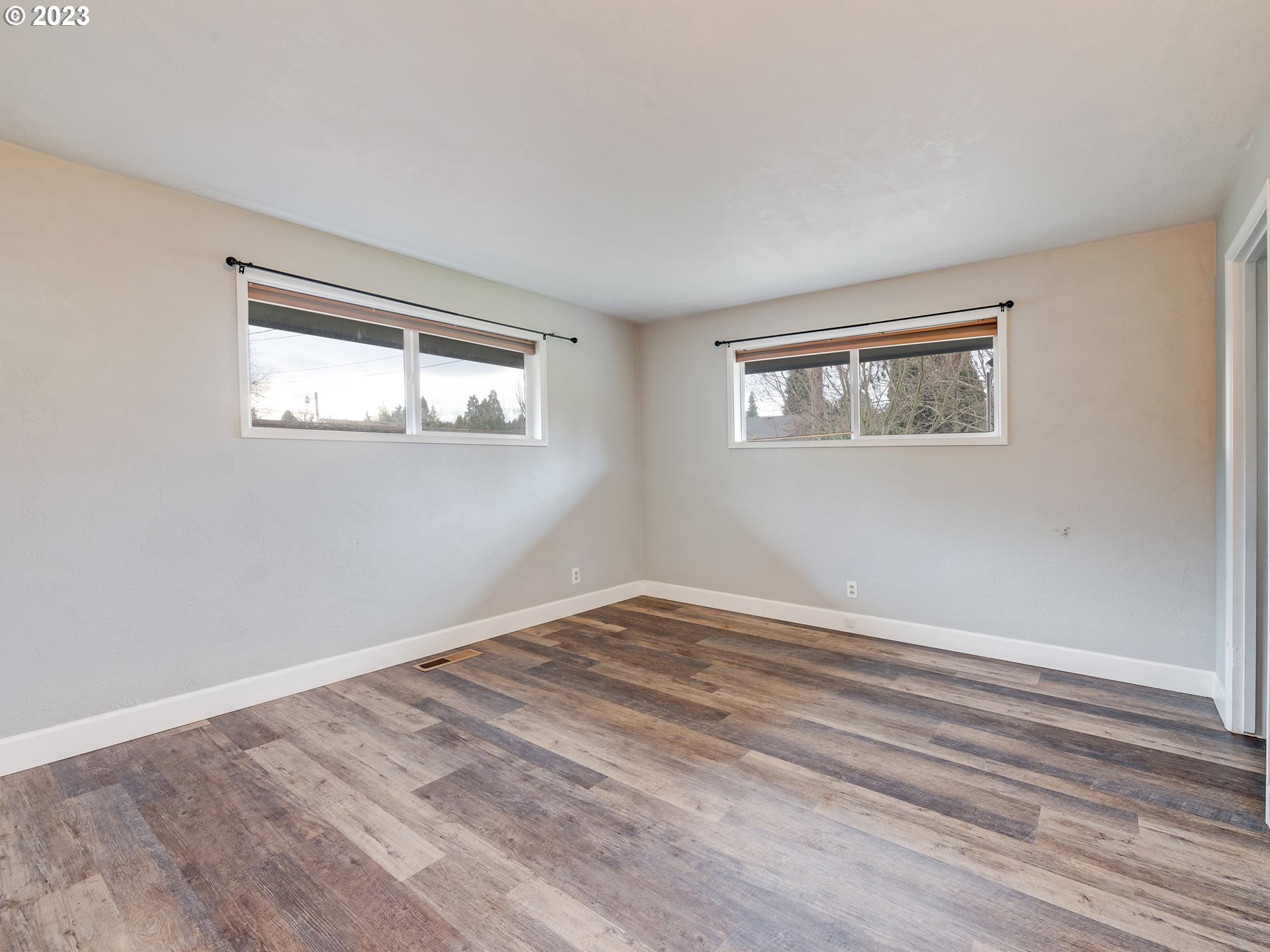 2552 Jasmine Street Eugene, OR 97404 - Photo 20 of 24 a view of empty room with window and wooden floor