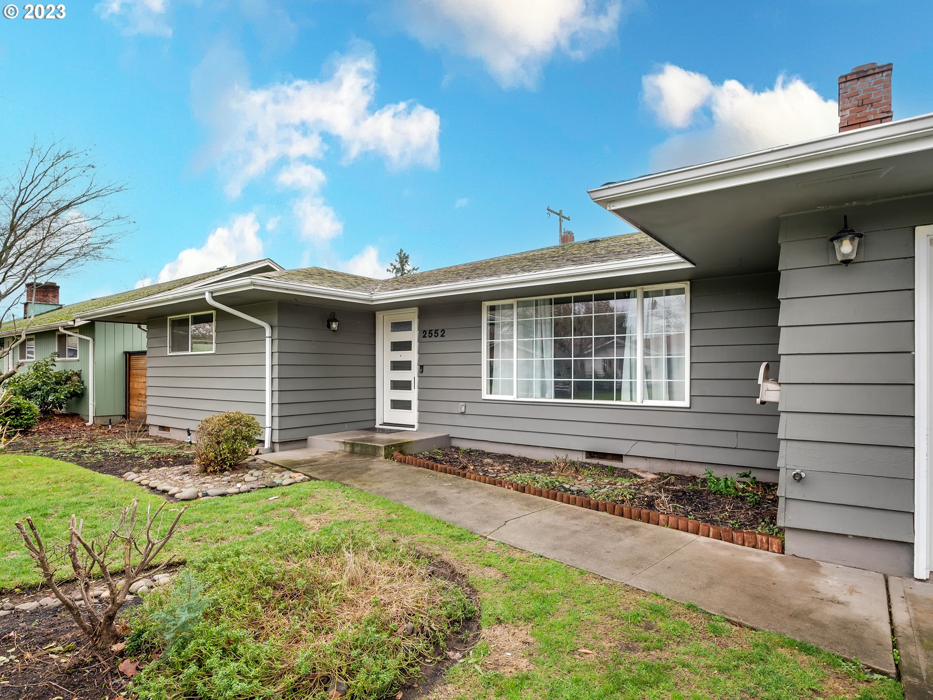 2552 Jasmine Street Eugene, OR 97404 - Photo 2 of 24 a front view of house with yard and trees in the background