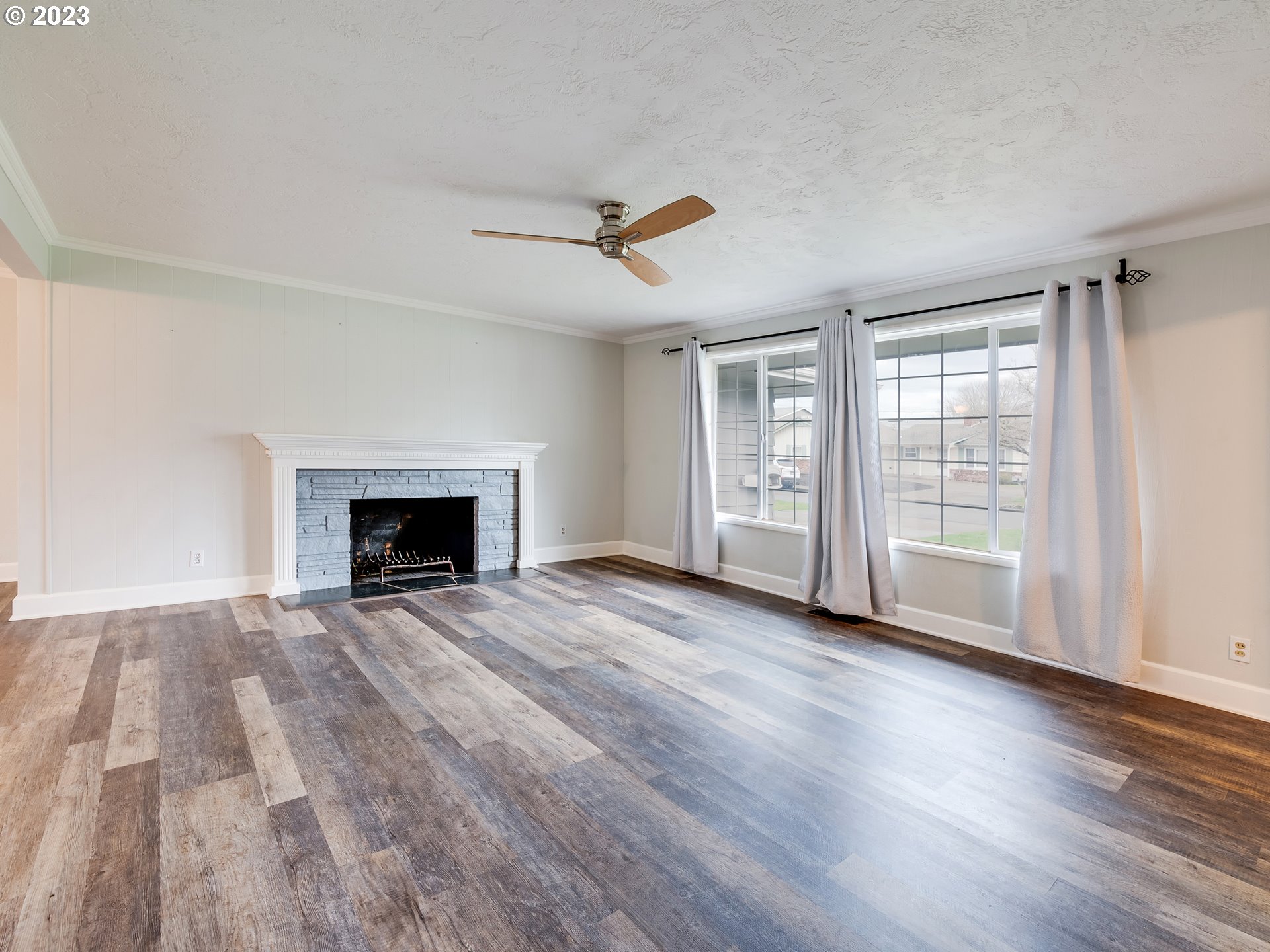 2552 Jasmine Street Eugene, OR 97404 - Photo 4 of 24 a view of empty room with wooden floor and fireplace