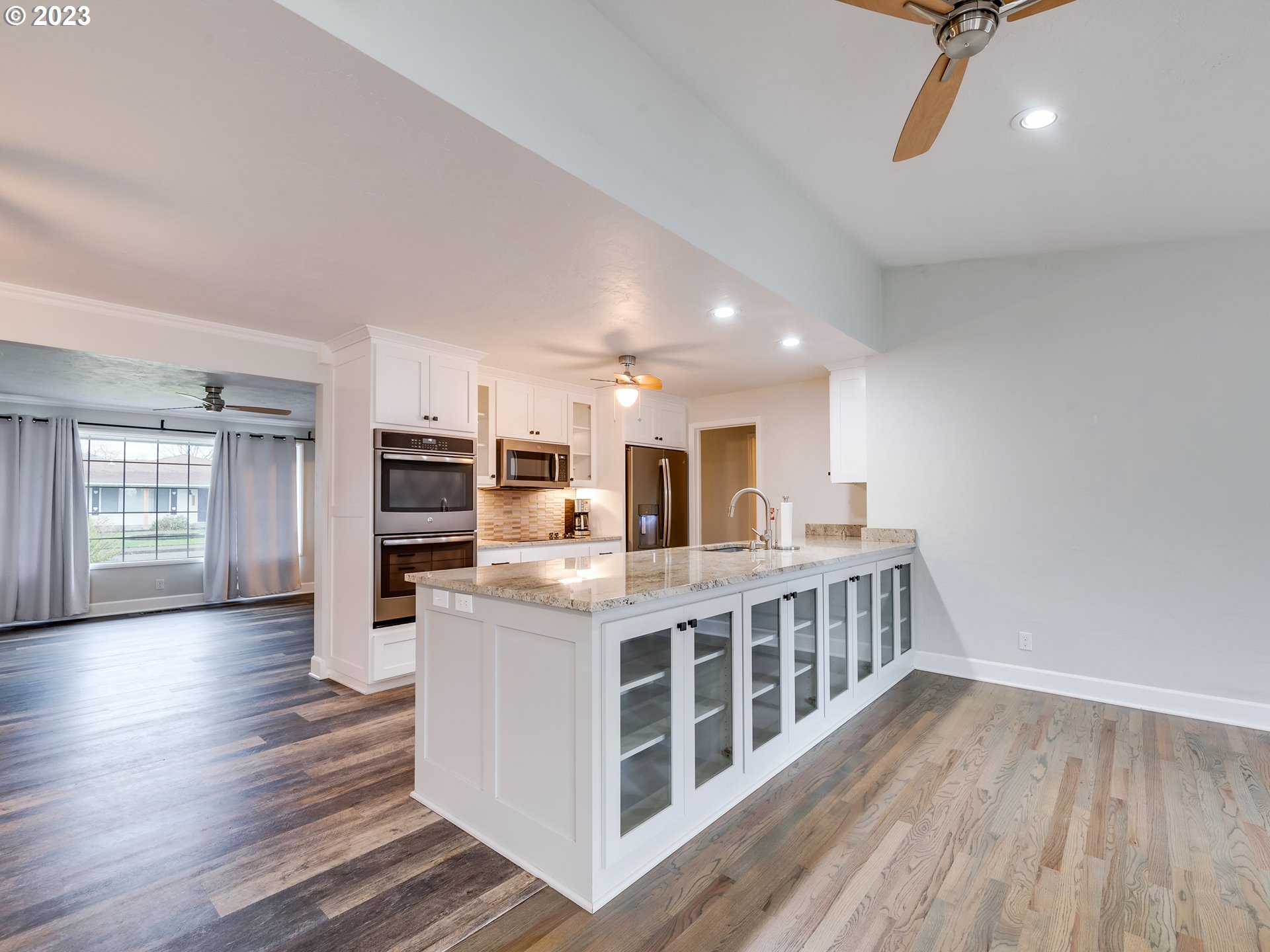 2552 Jasmine Street Eugene, OR 97404 - Photo 7 of 24 a view of kitchen with kitchen island wooden floor center island and stainless steel appliances